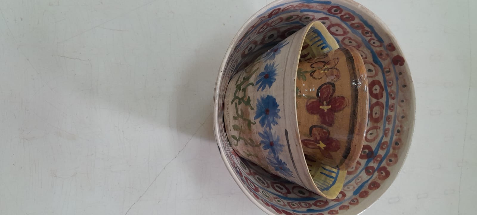 קערות קרמיקה מצוירות בפרחים, אחת בתוך השנייה